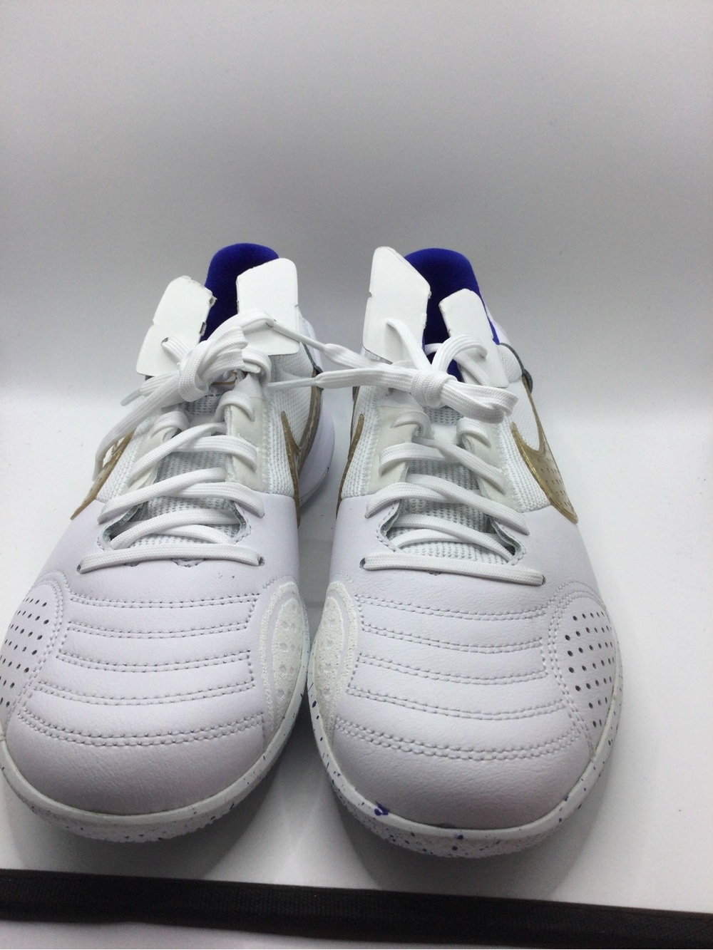 Nike White Sneakers with Gold Swoosh and Blue Collar